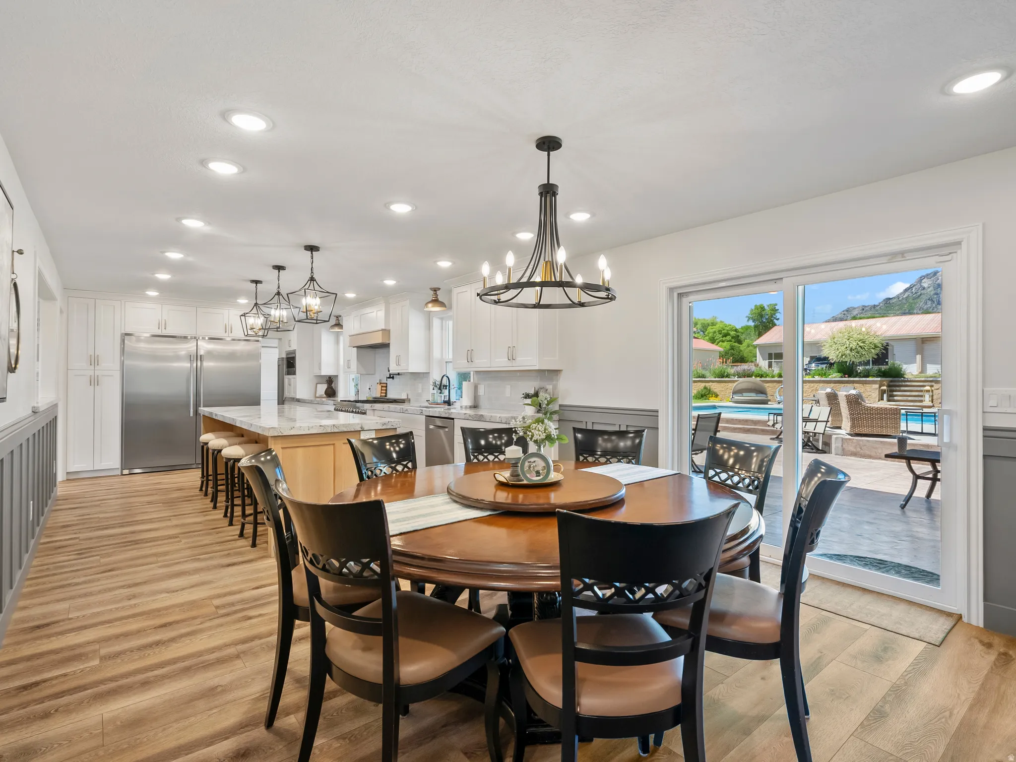 Open concept dining and kitchen area featuring wood-finish flooring