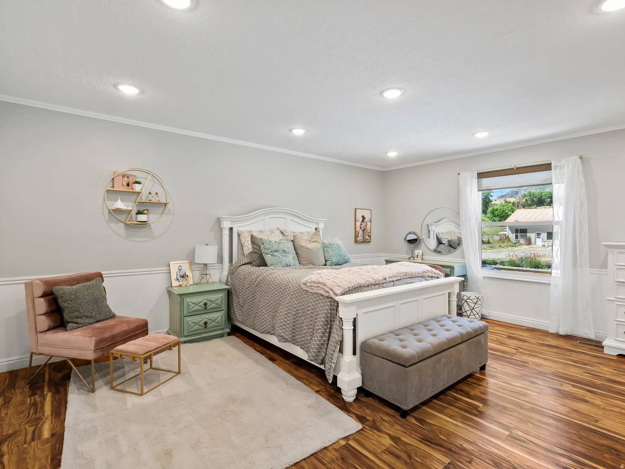 Spacious room featuring rich wood-finish flooring, recessed lighting, and a window with white trim