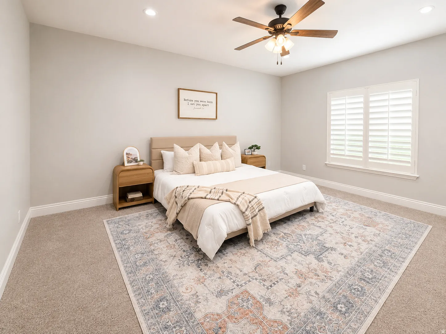 Carpeted room featuring a ceiling fan with integrated lighting, recessed ceiling lights, and window with plantation shutters