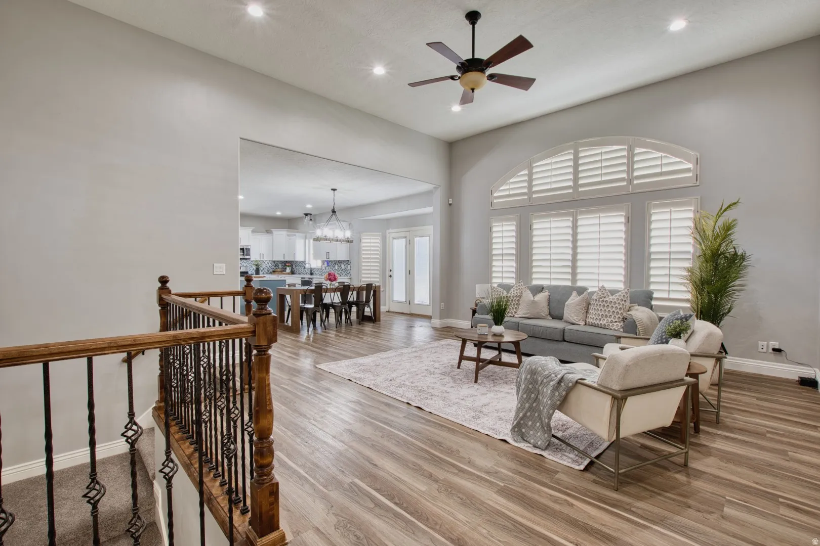 Spacious living area featuring high ceilings, recessed lighting, and wood-finish flooring