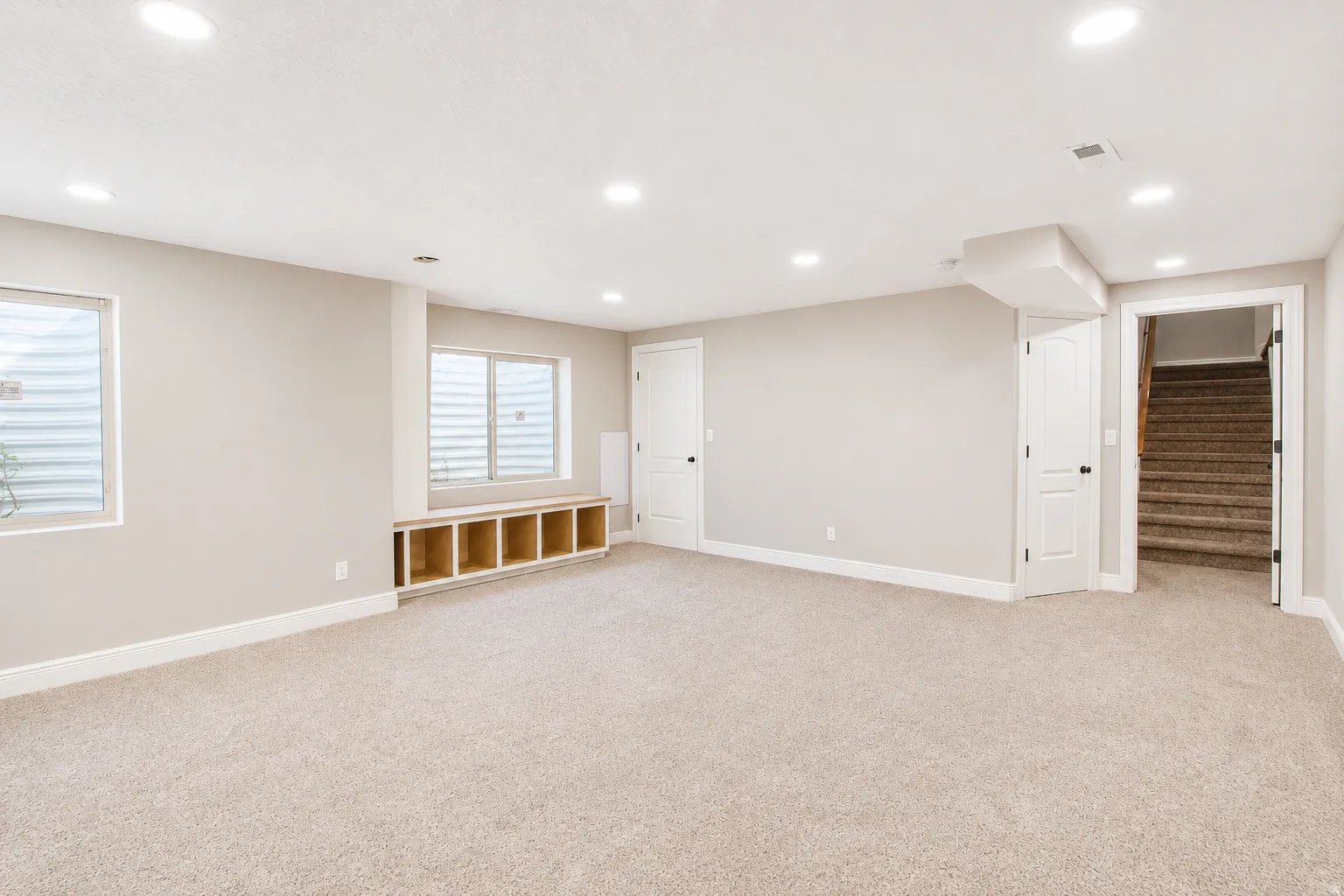 Spacious room featuring neutral carpeting, recessed lighting, and light-toned wall paint