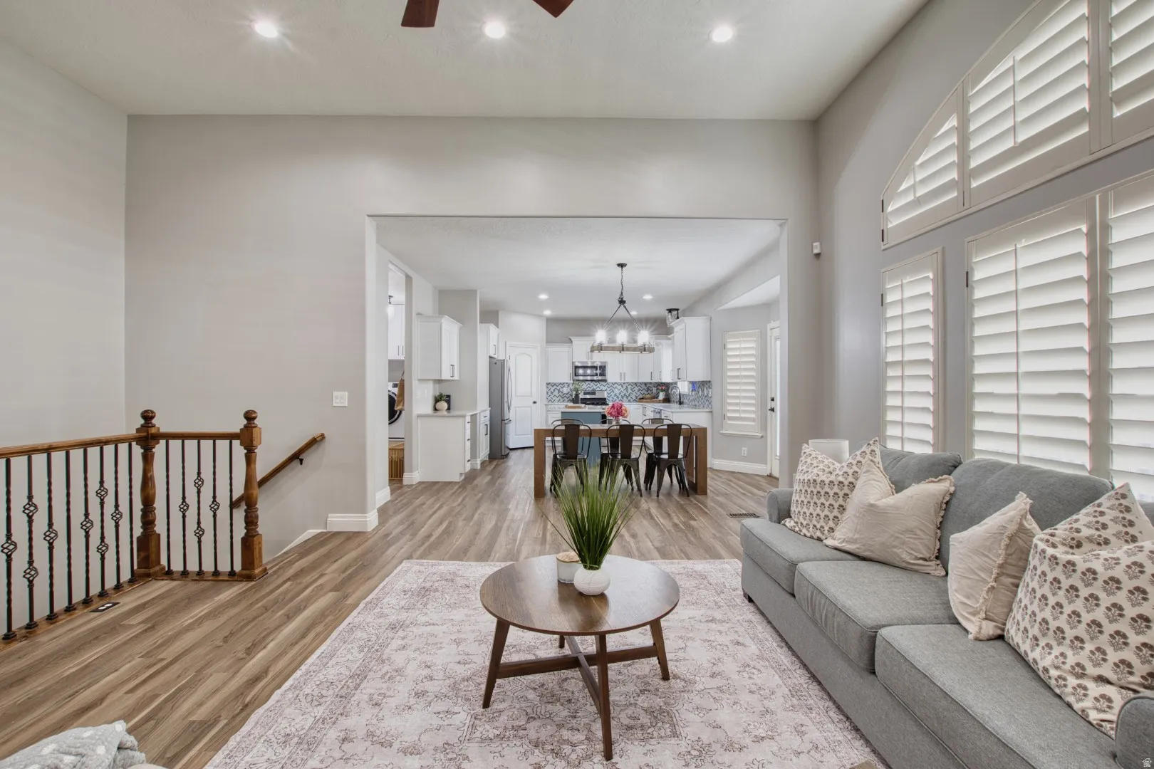 Spacious living area featuring high ceilings, recessed lighting, and wood-finish flooring