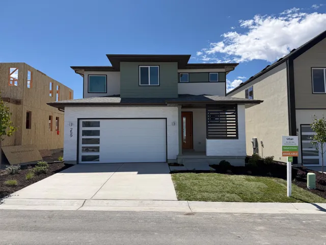 Contemporary exterior with a multi-textured facade, featuring a modern garage door with frosted glass panels, a covered entry with slatted privacy screen, and a concrete driveway