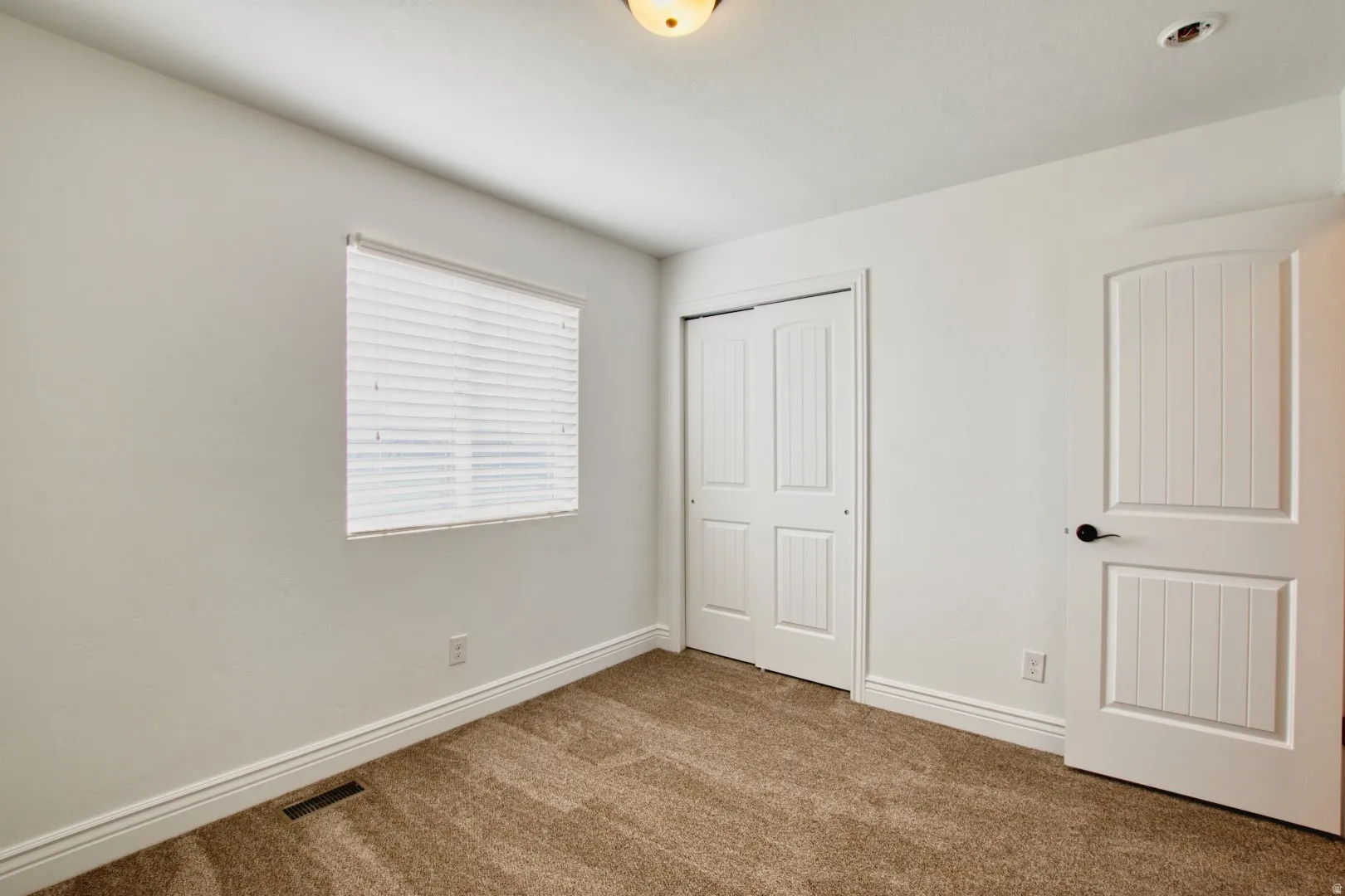 Neutral tone wall paint with white trim