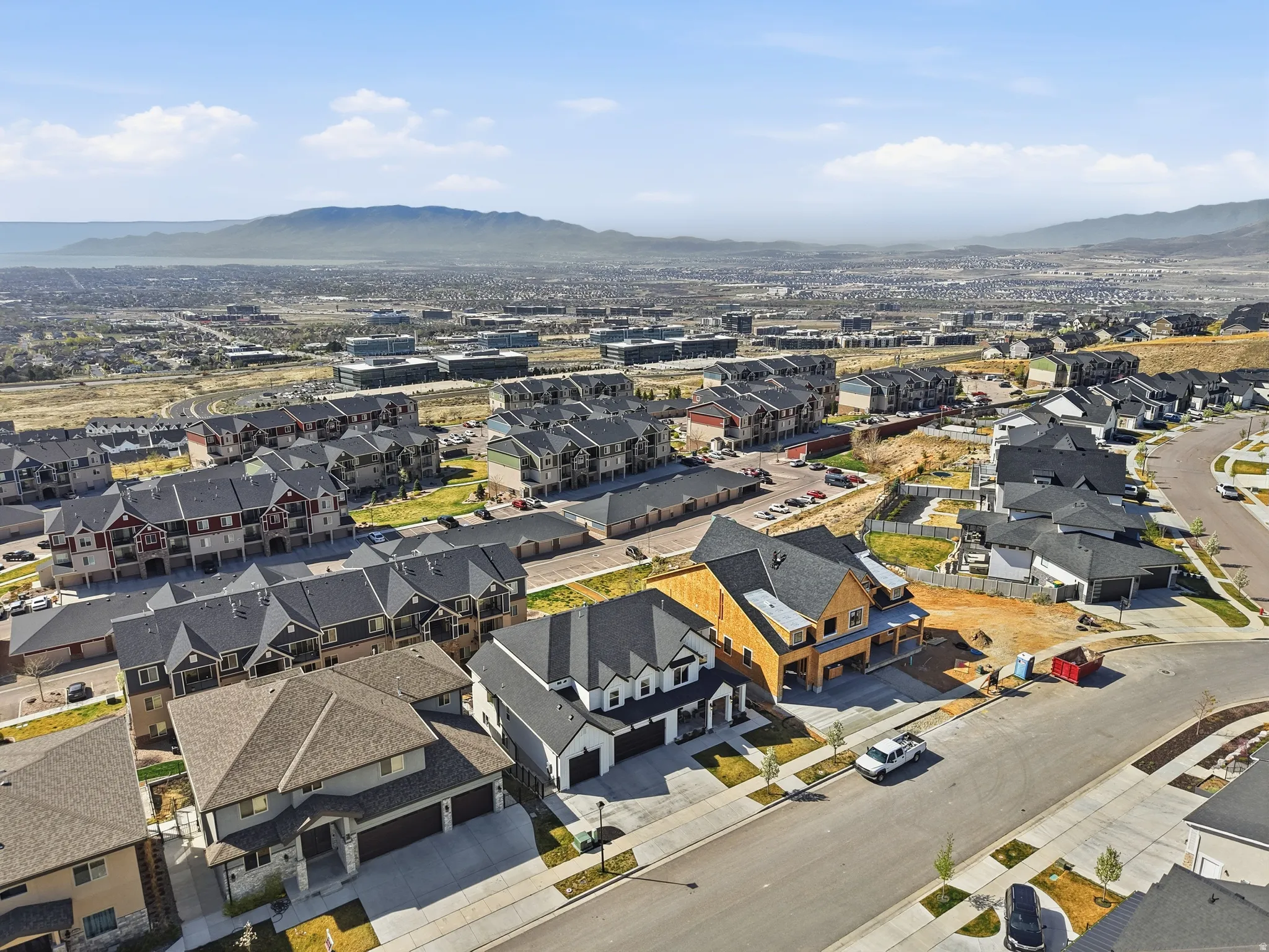 Aerial perspective showcasing residential properties with mountain and distant water features