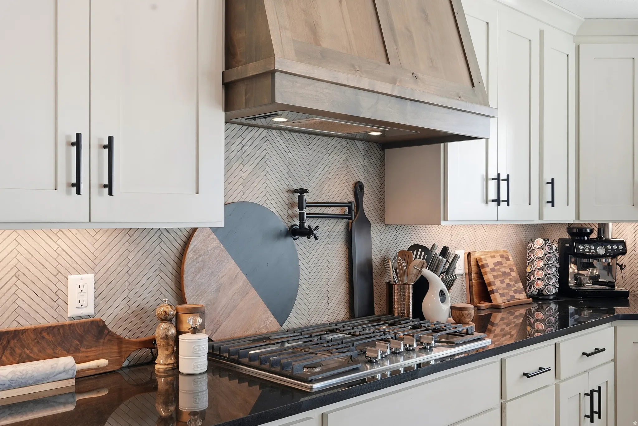 Wood-finish range hood over a stainless steel gas cooktop