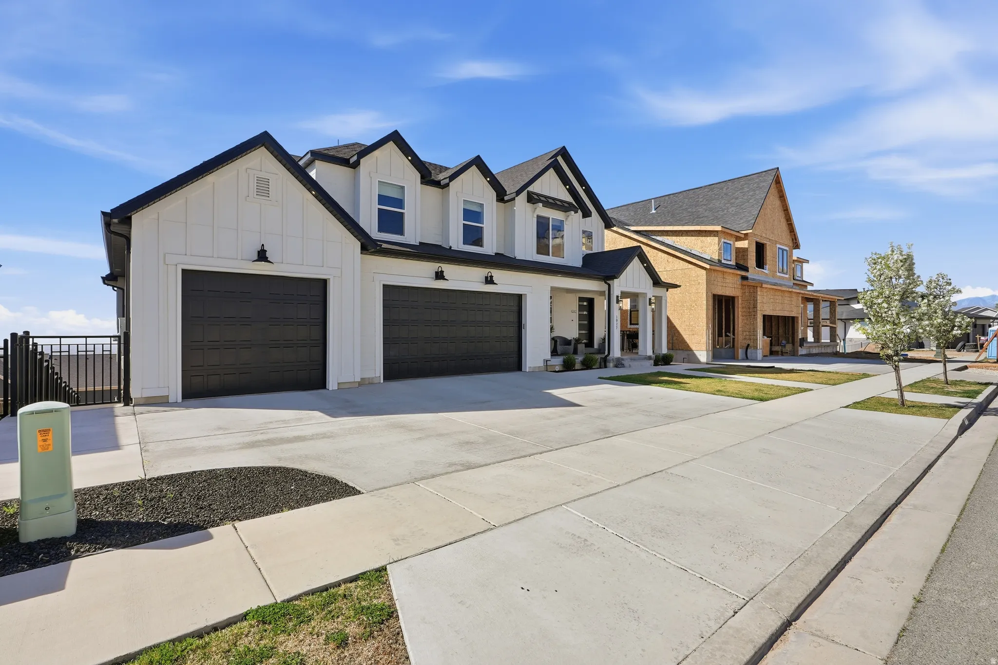 Modern farmhouse exterior featuring white board and batten siding with black trim accents