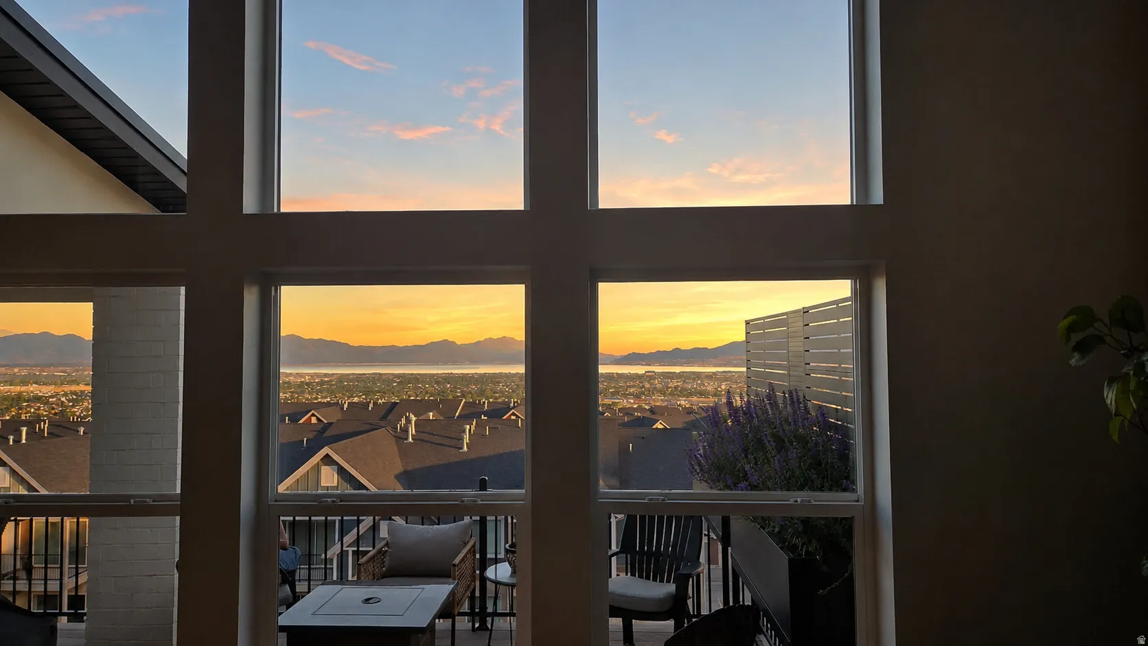 Floor-to-ceiling windows with grid pattern framing an expansive landscape