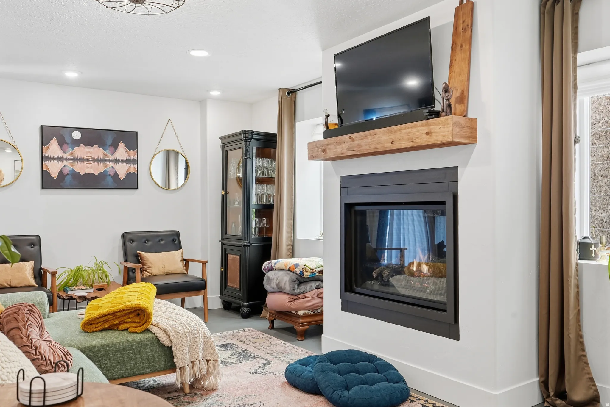 Built-in fireplace with a minimalist black frame and a wood-finish mantel