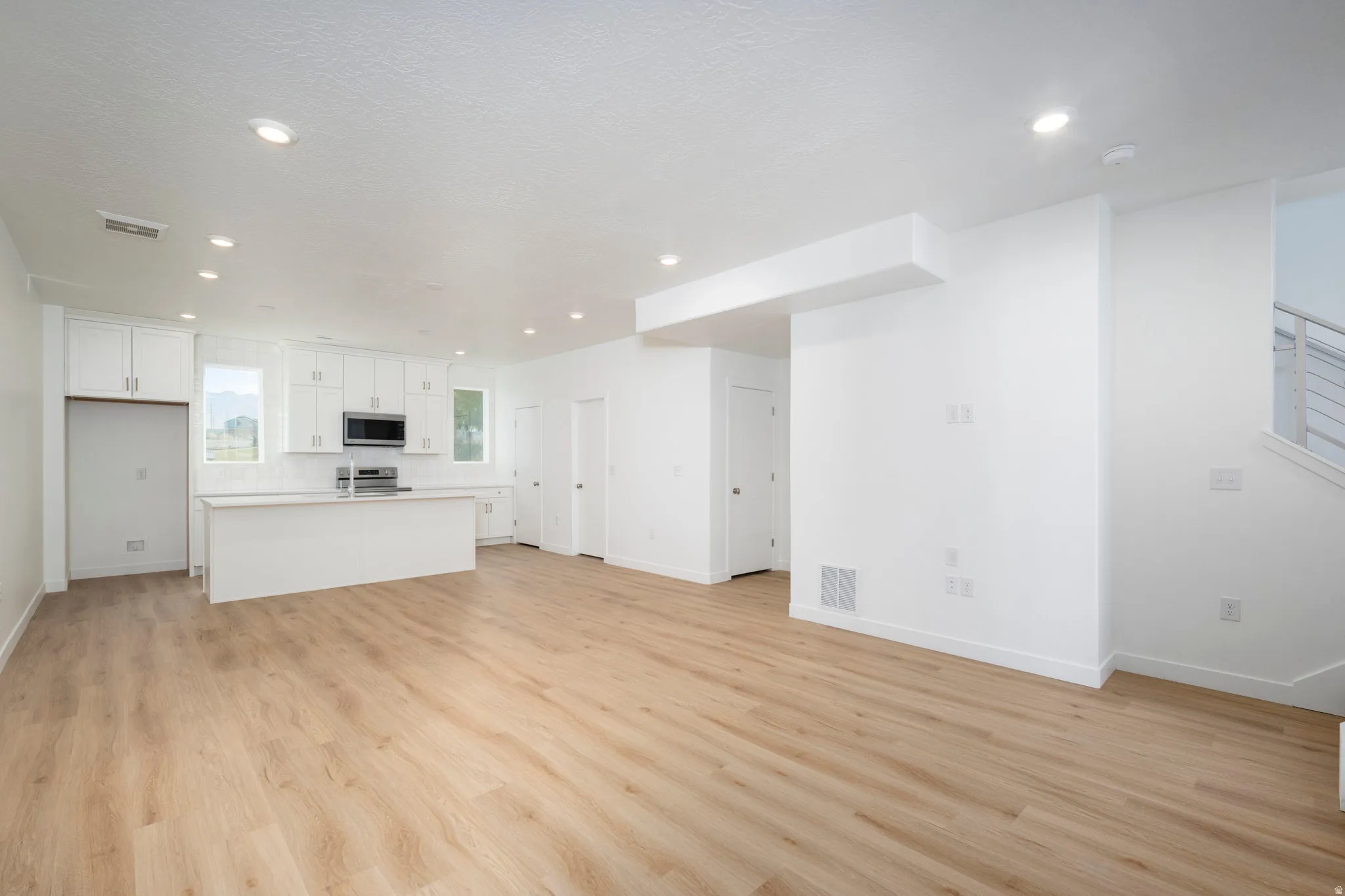 Open-concept living area featuring wood-finish flooring throughout