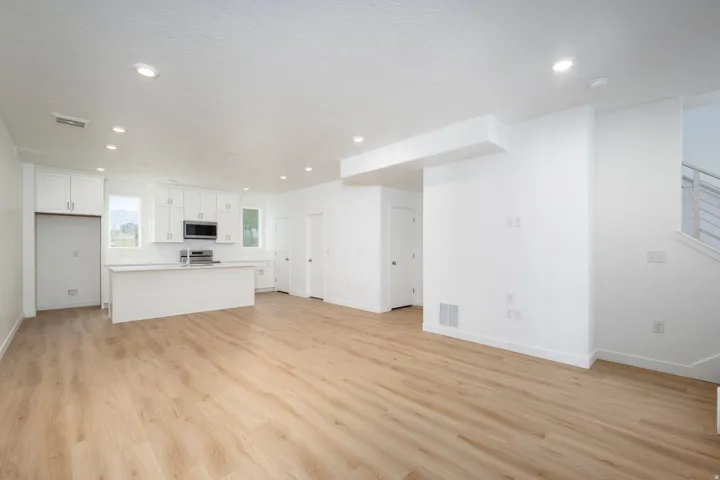Open-concept living area featuring wood-finish flooring throughout