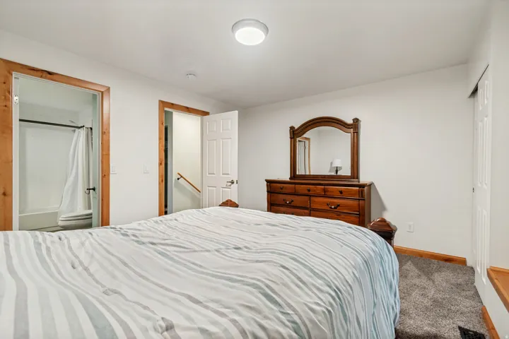 Carpeted interior with white walls and wooden trim