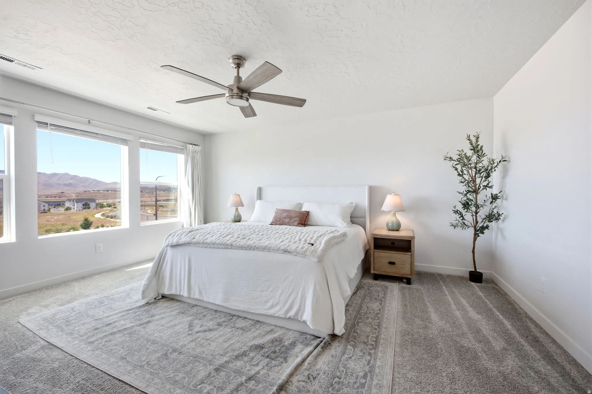 Bedroom featuring a multi-paned window wall, recessed lighting, and a ceiling fan with integrated lighting