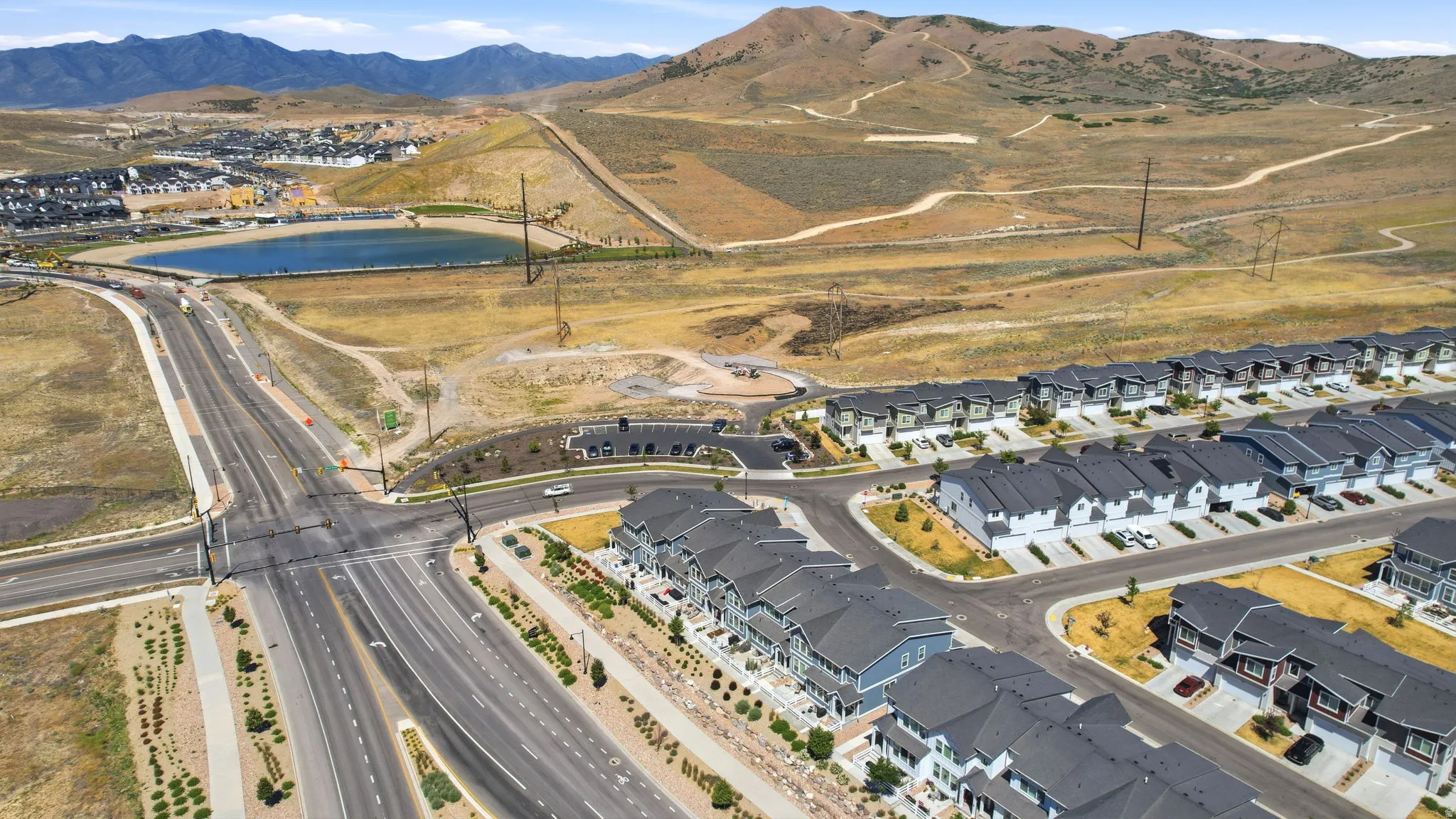 Expansive community featuring multiple rows of residential buildings with dark roofs and light-colored facades