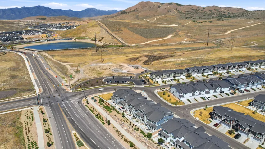 Expansive community featuring multiple rows of residential buildings with dark roofs and light-colored facades
