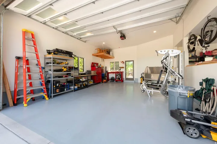 Spacious garage with light gray flooring and white walls
