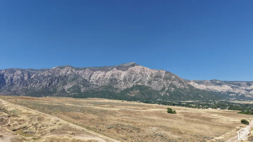 Expansive mountain backdrop with a clear blue sky