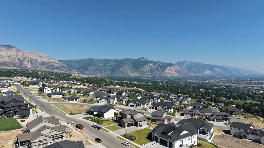 Expansive aerial perspective showcasing a residential development with a mountainous backdrop