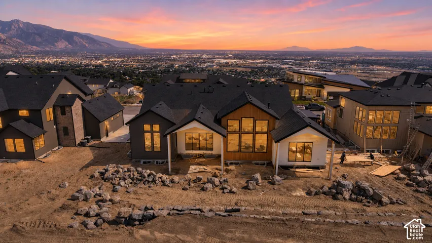 Contemporary residence featuring a dark gray exterior with wood-finish siding accents and white trim