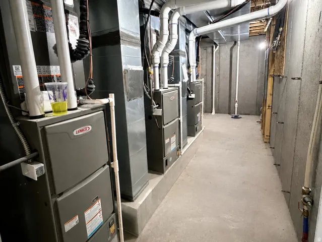 Multiple HVAC units on raised platforms with exposed ductwork and piping