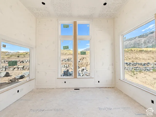 Expansive windows, detailed wall paneling, and recessed lighting