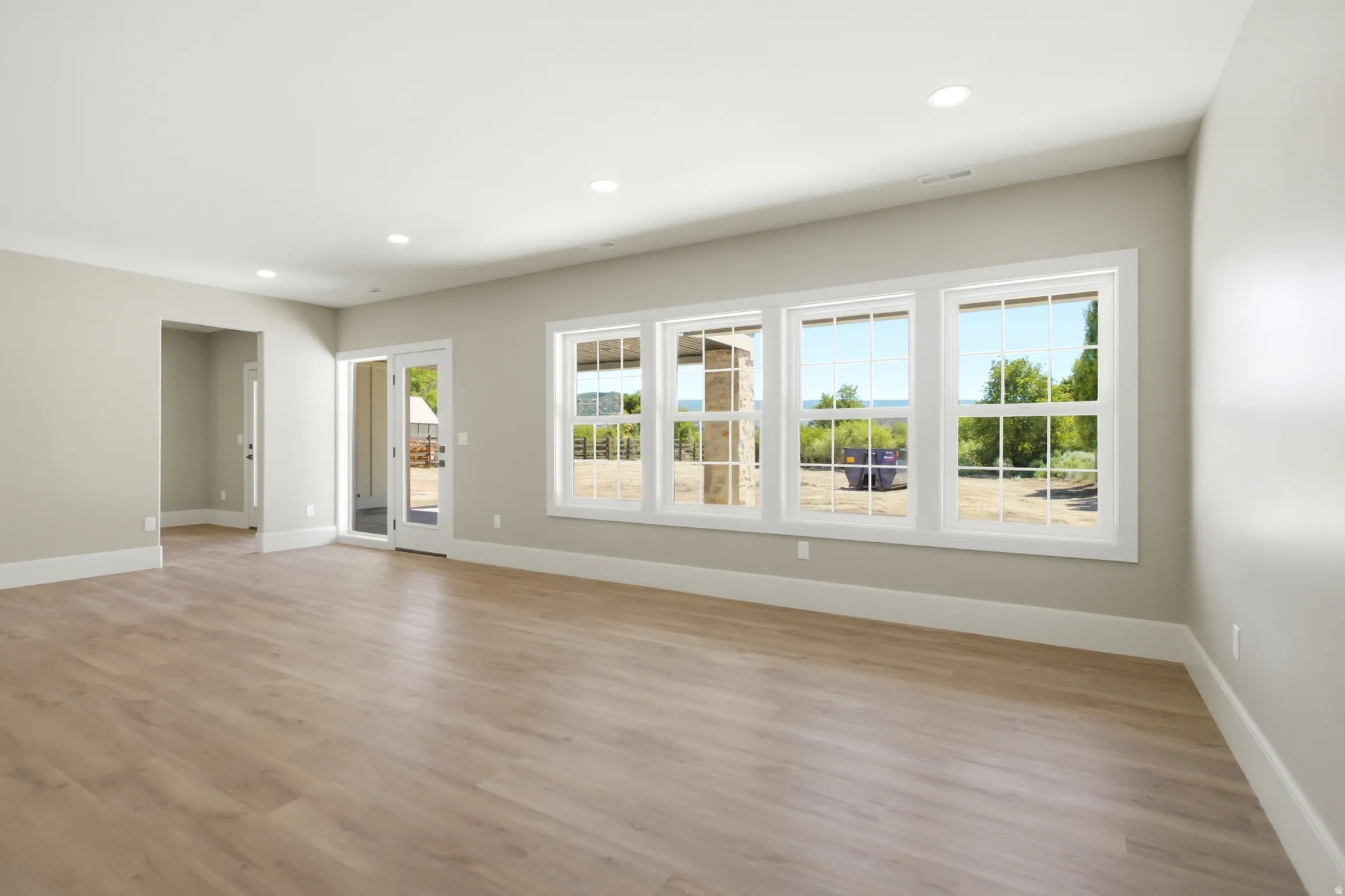 Spacious room featuring recessed lighting, and multiple windows with white trim