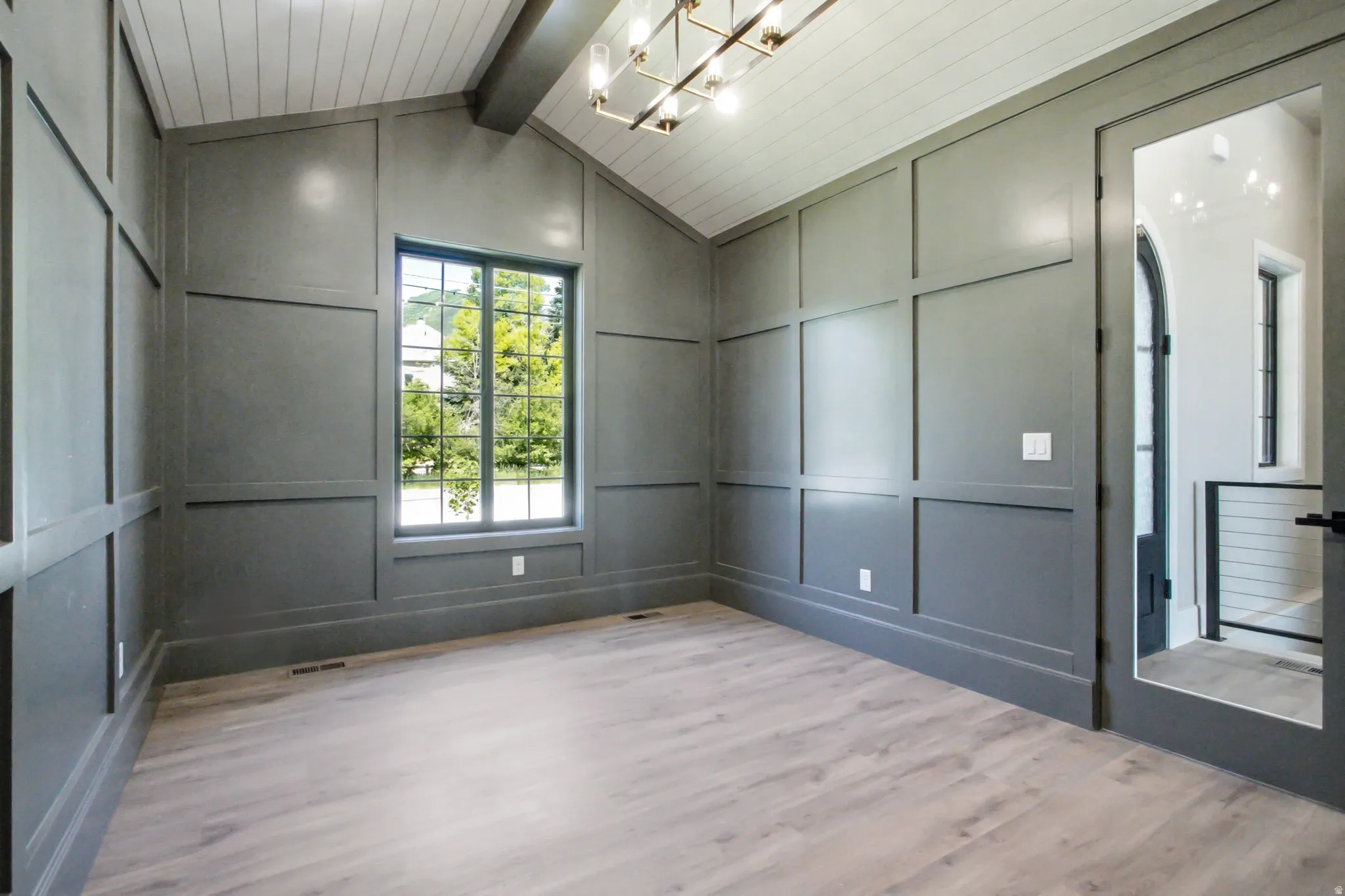 Vaulted ceiling with shiplap detailing and exposed beam