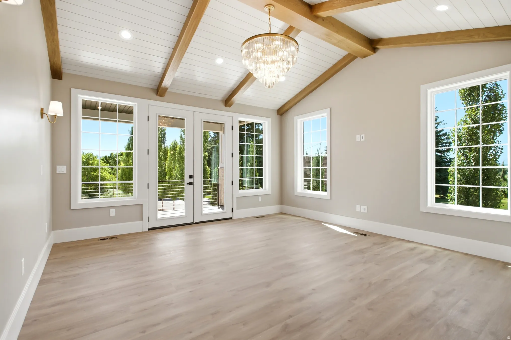 Primary Bedroom vaulted ceiling featuring exposed wood beams and shiplap paneling