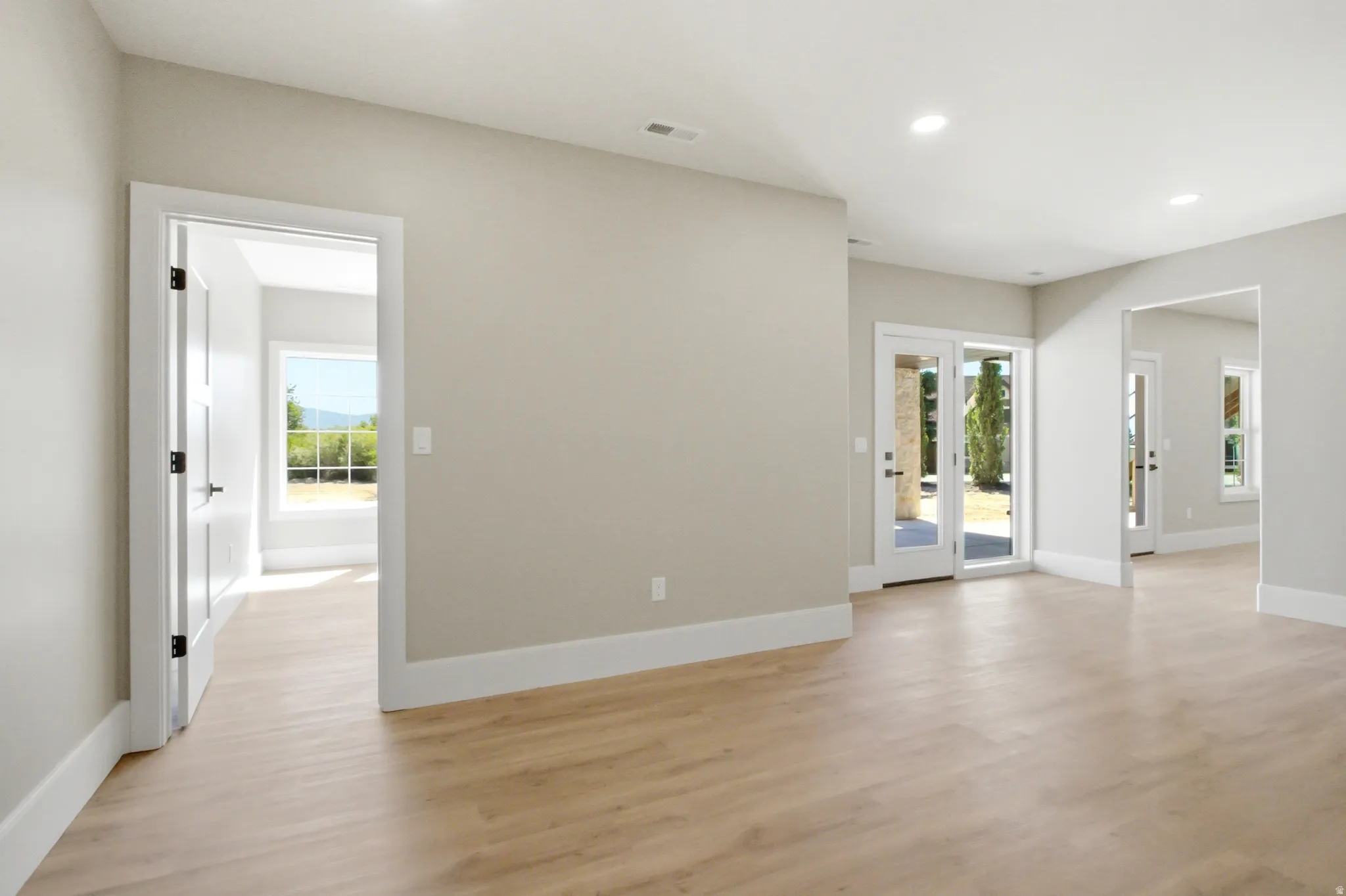 Open-concept living area featuring light  recessed lighting, and a neutral wall palette