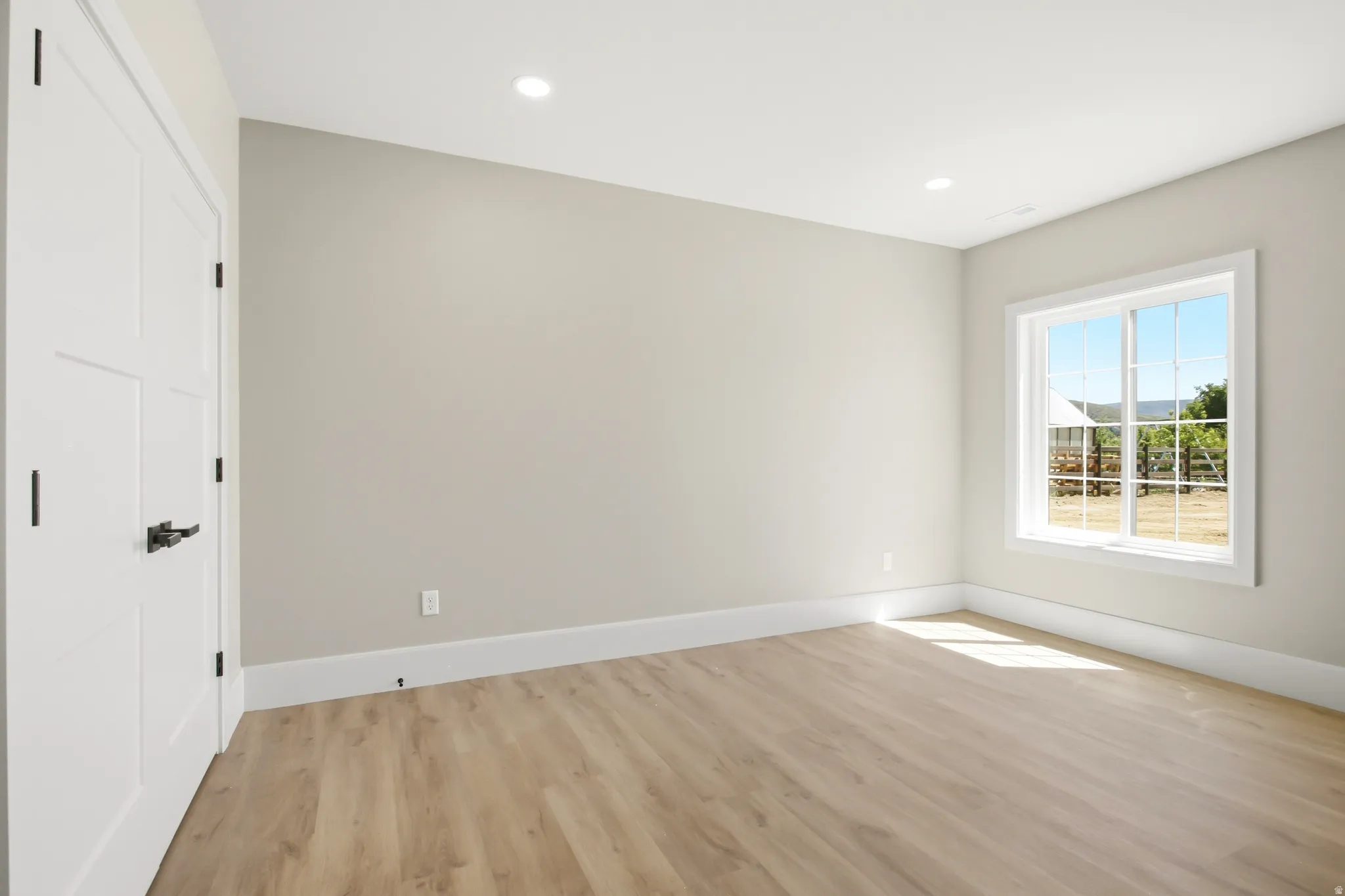 Spacious room featuring recessed lighting, and a multi-pane window