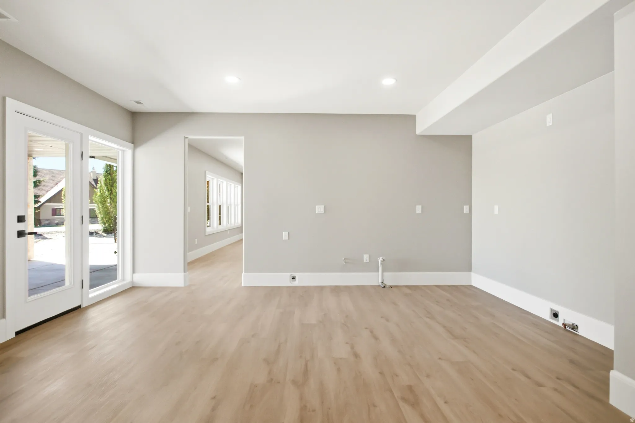 Lower level plumbed for full kitchen featuring, neutral gray walls, recessed lighting, and white baseboards