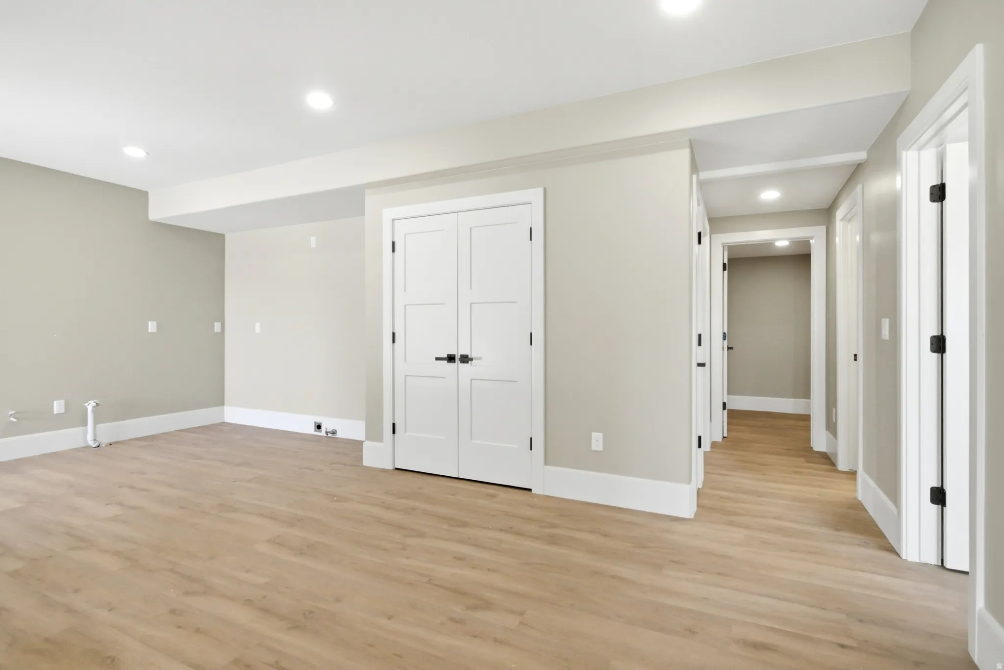 Lower level plumbed for full kitchen featuring, neutral gray walls, recessed lighting, and white baseboards