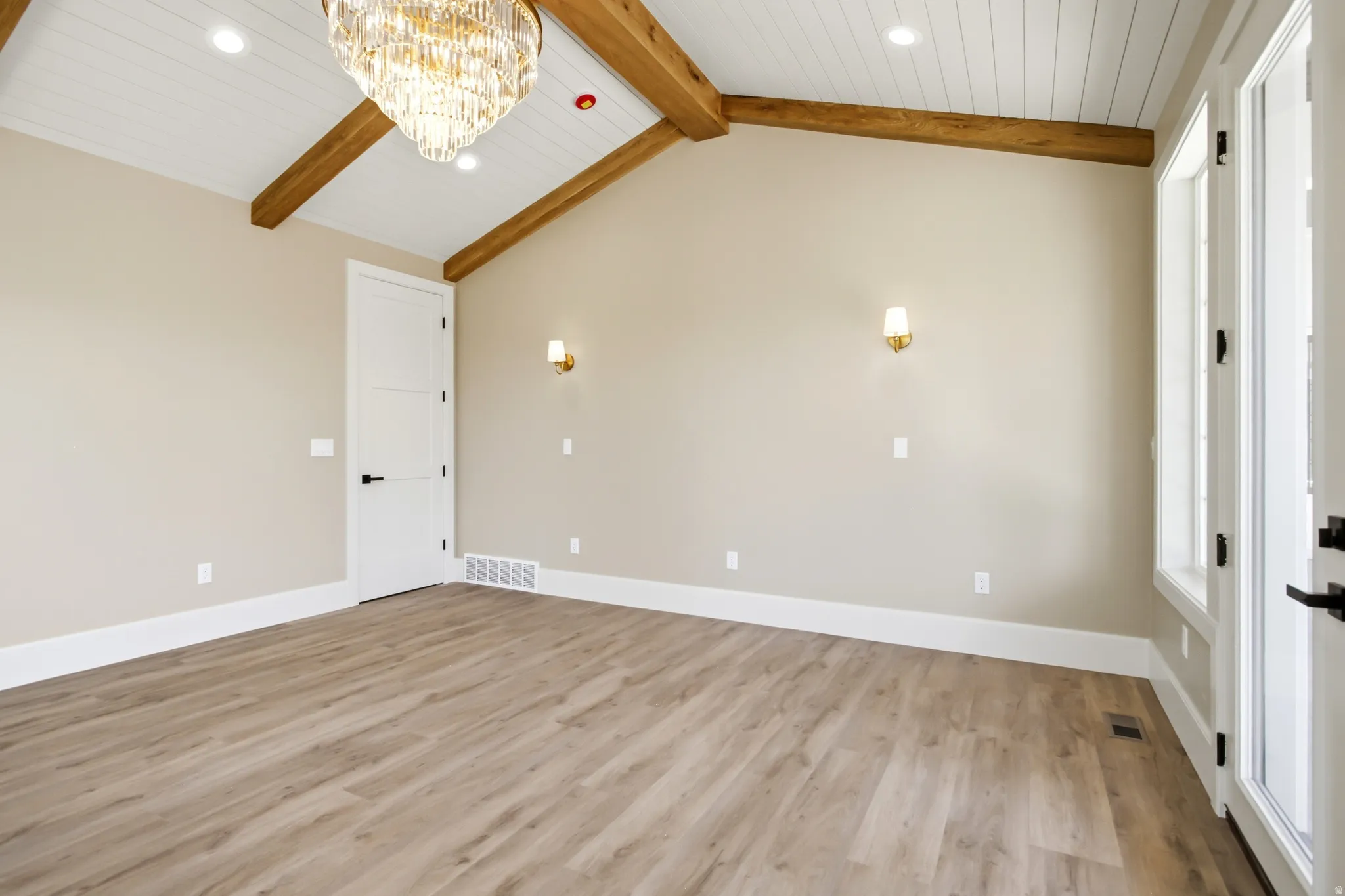 Primary Bedroom vaulted ceiling featuring exposed wood beams and shiplap paneling