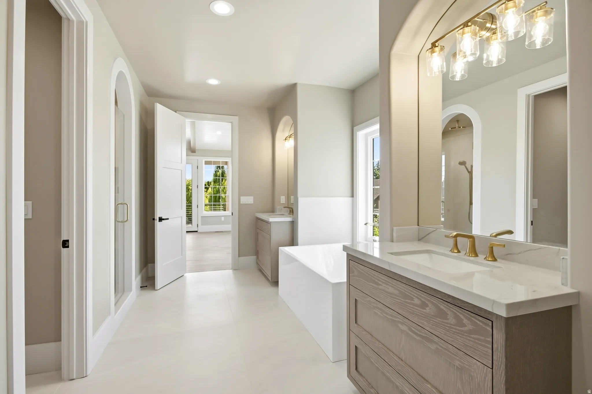 Dual vanity with light wood-finish cabinetry and white countertops