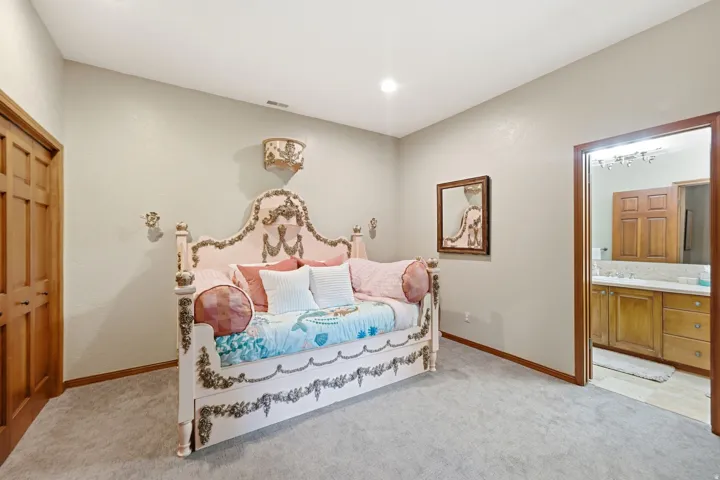 Room featuring light gray walls, gray carpeting, and natural wood baseboards