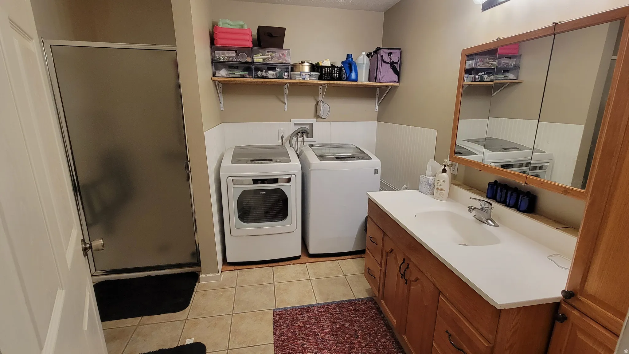 Full bathroom with integrated laundry appliances