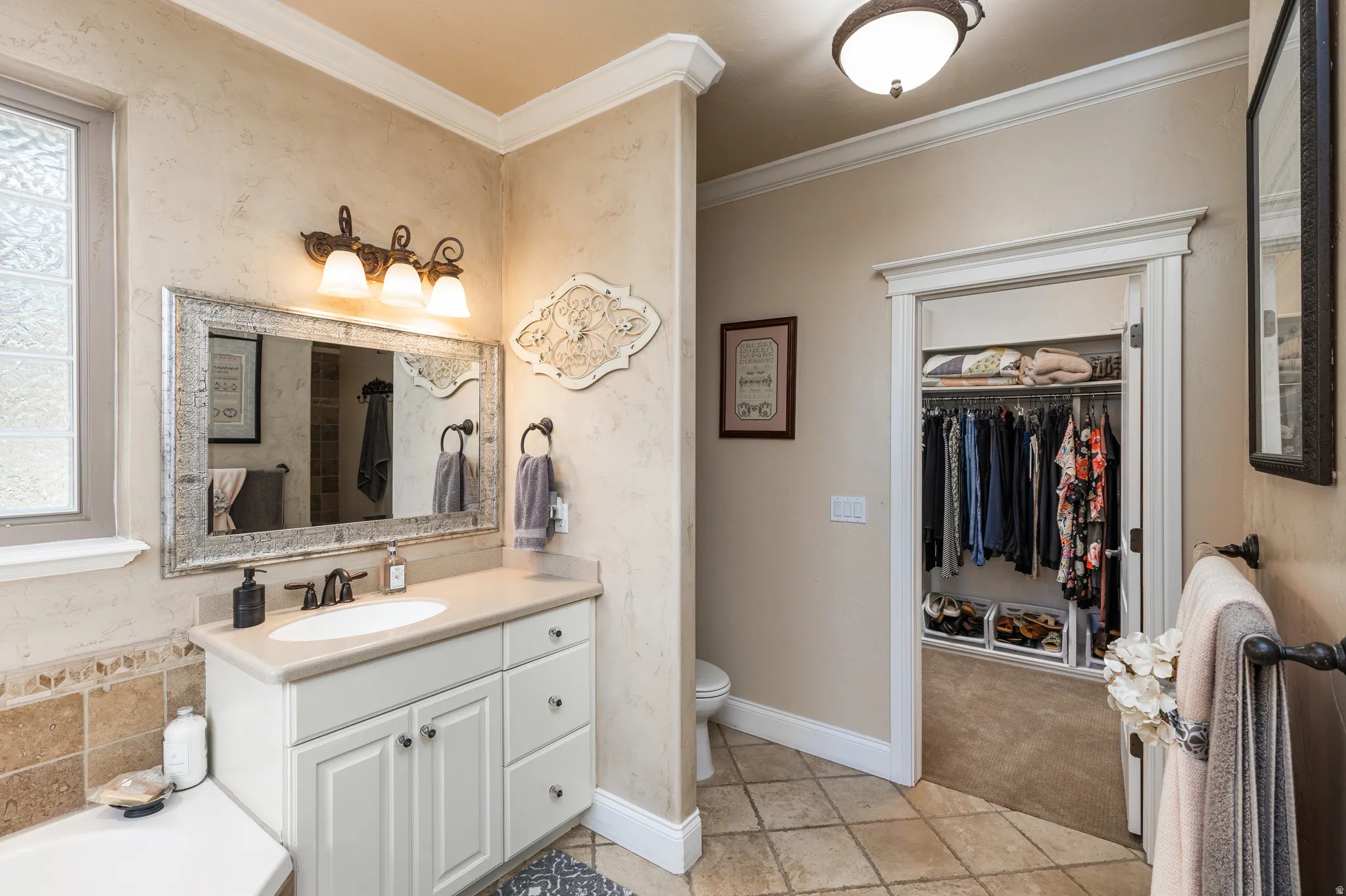 Vanity featuring a single basin, light-colored countertop, and storage cabinetry