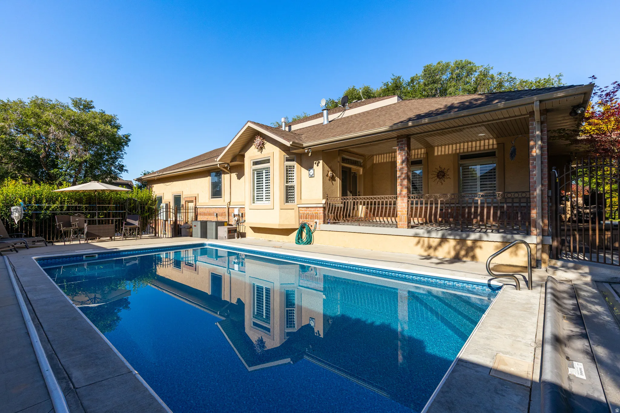 Outdoor swimming pool with integrated steps, surrounded by a concrete deck