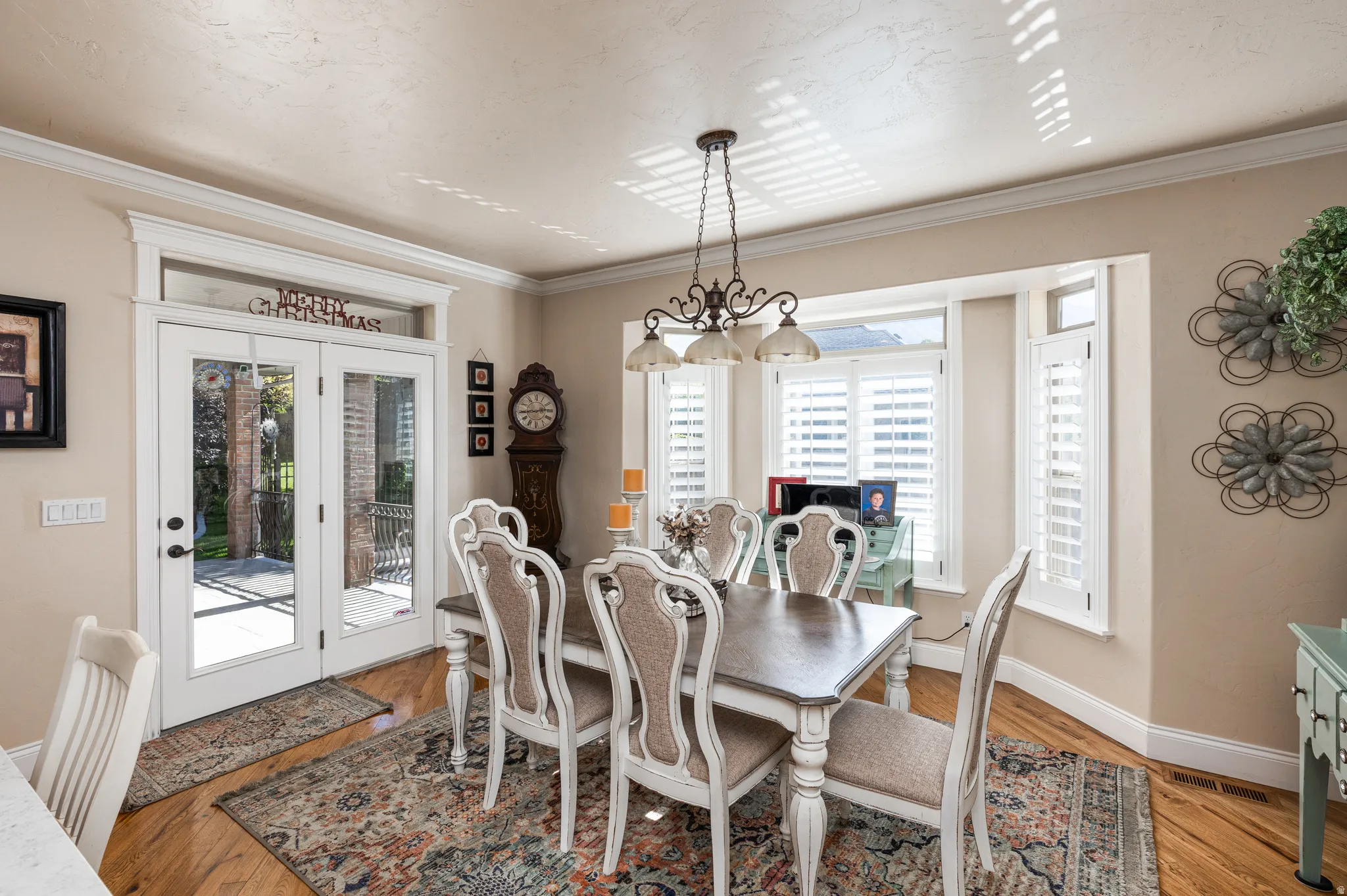 Wood-finish flooring throughout, featuring a bay window with plantation shutters