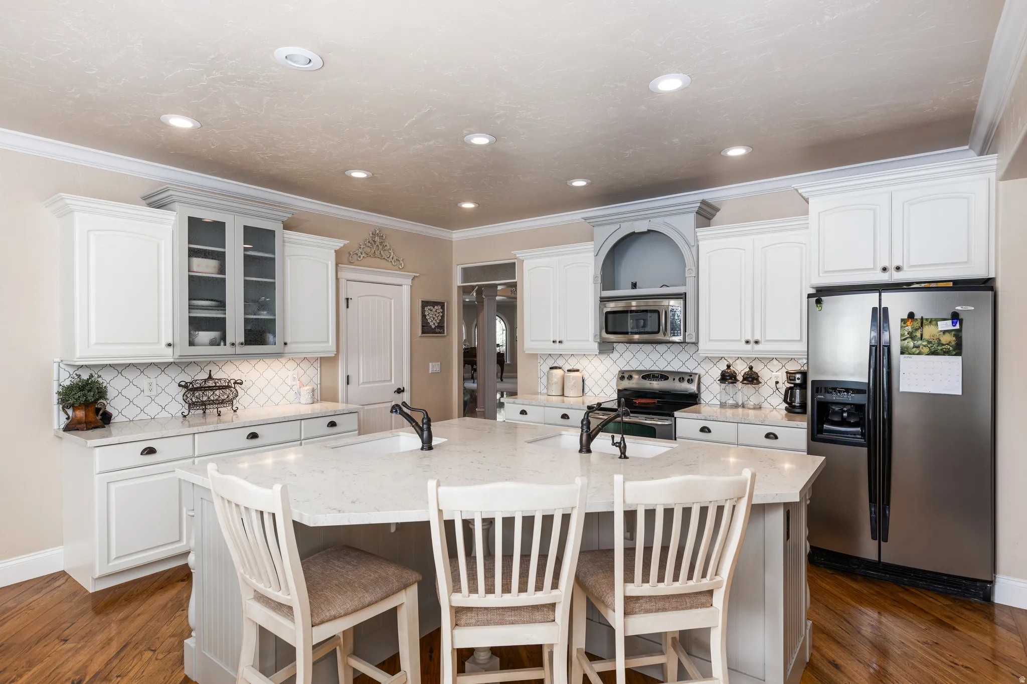 Kitchen featuring wood-finish flooring, recessed lighting, and crown molding