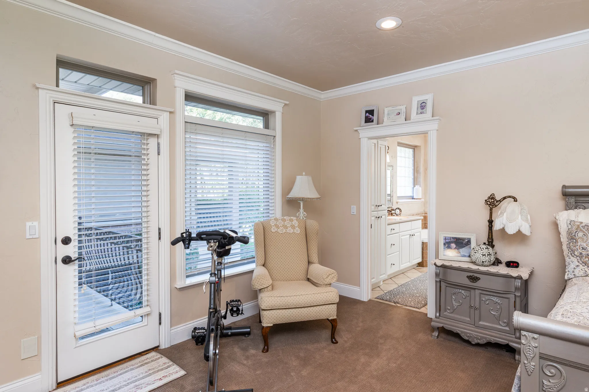 Light-colored wall paint and carpet flooring highlight the white trim and crown molding