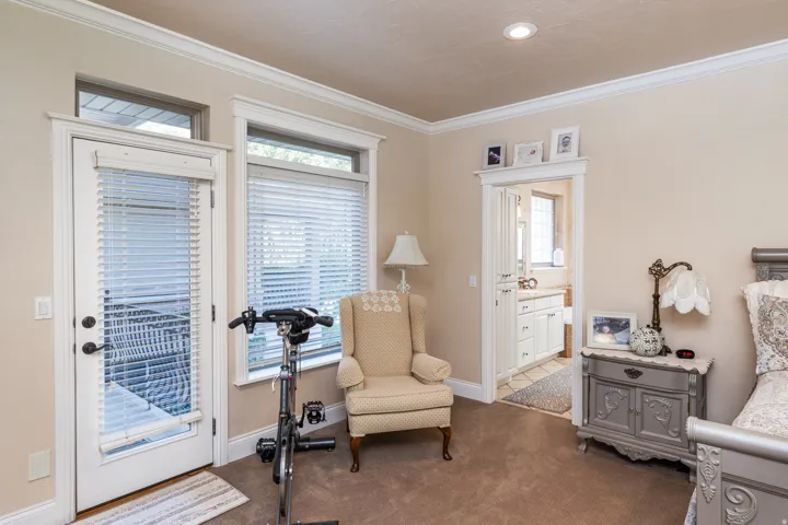 Light-colored wall paint and carpet flooring highlight the white trim and crown molding