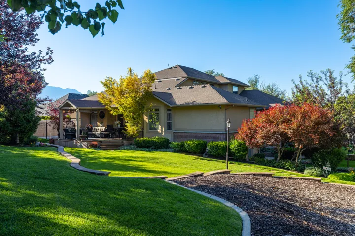 Expansive manicured lawn with mature trees and landscaping