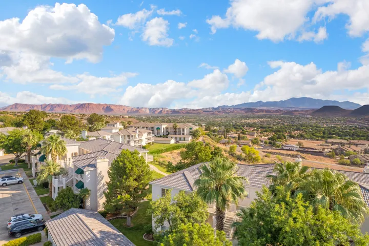 Expansive landscape featuring distant mountains and a residential community