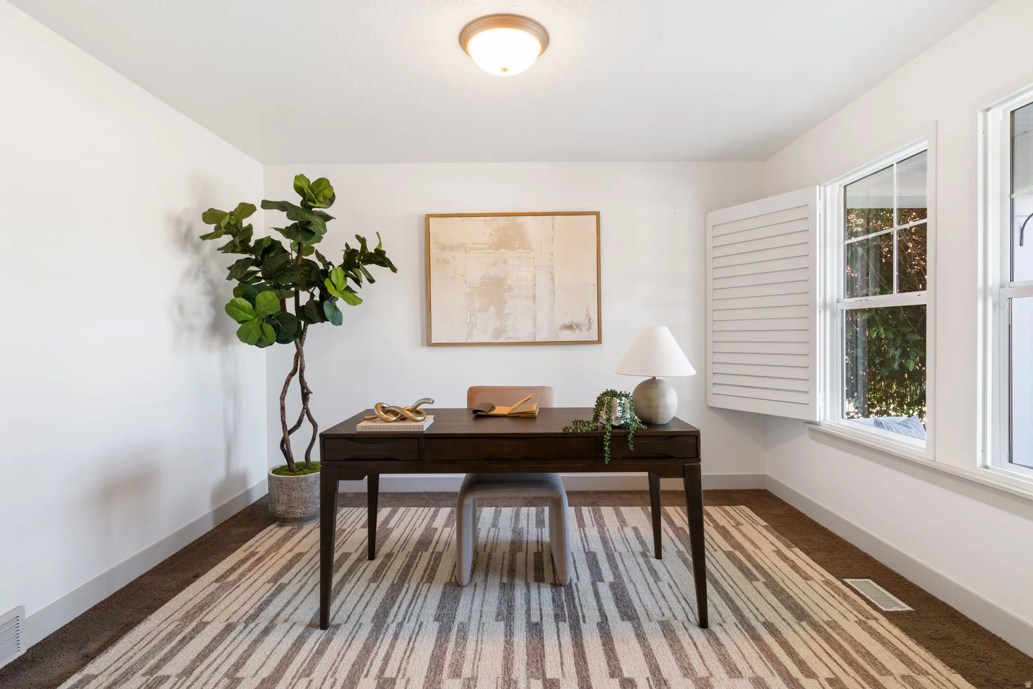 Bright room featuring white walls, a flush-mount ceiling light fixture, and two large windows providing natural light