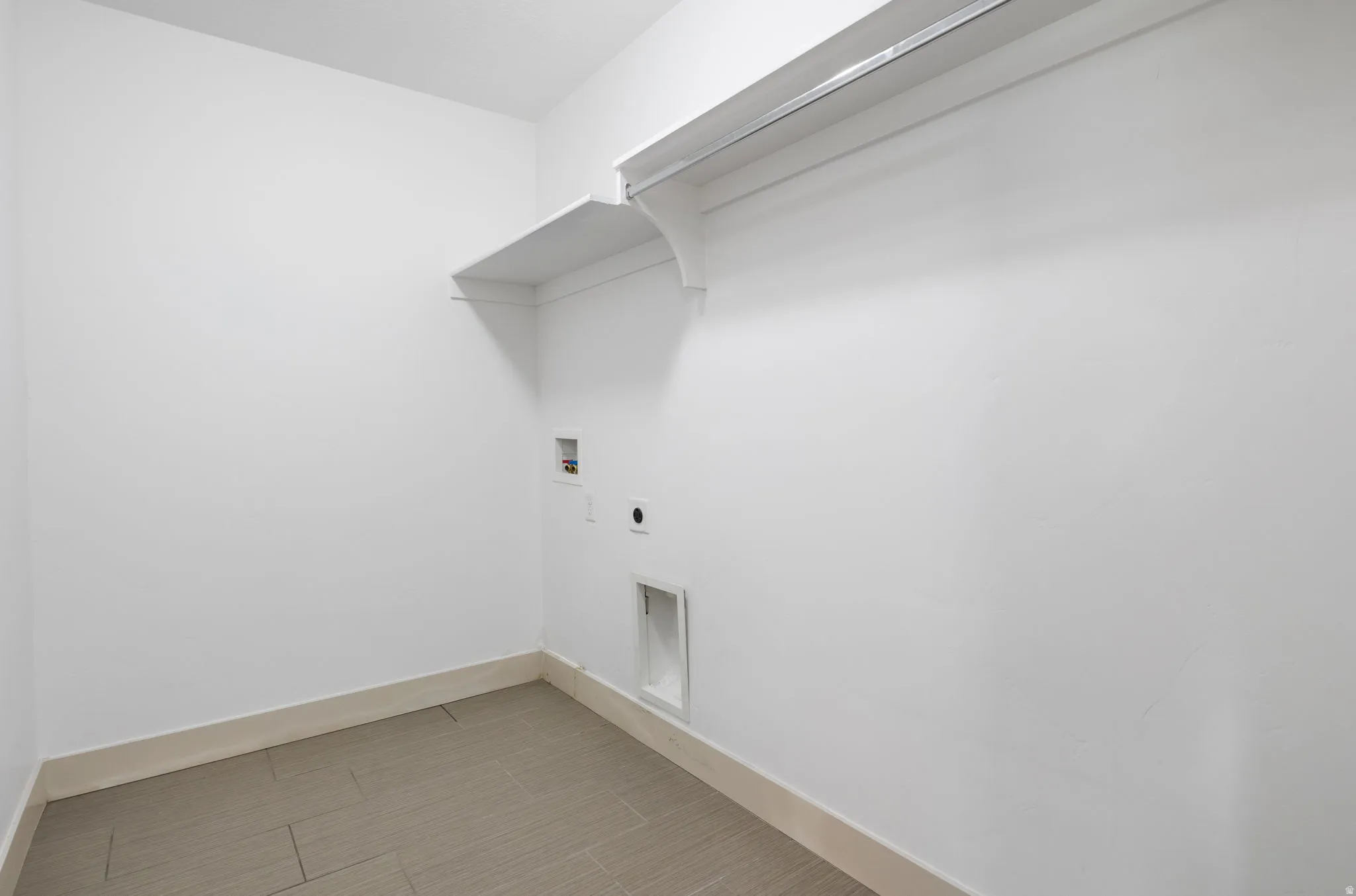 Dedicated utility space featuring laundry connections