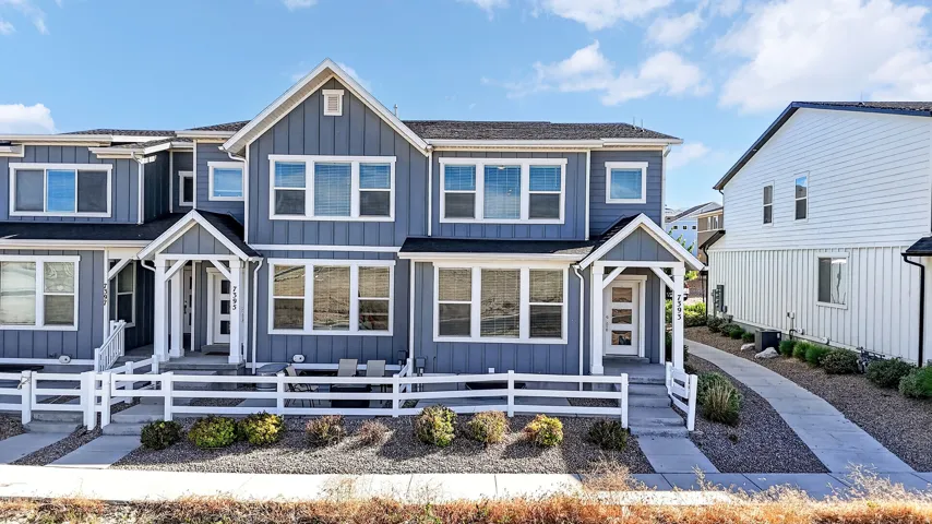 Modern townhome exterior featuring blue siding with white trim