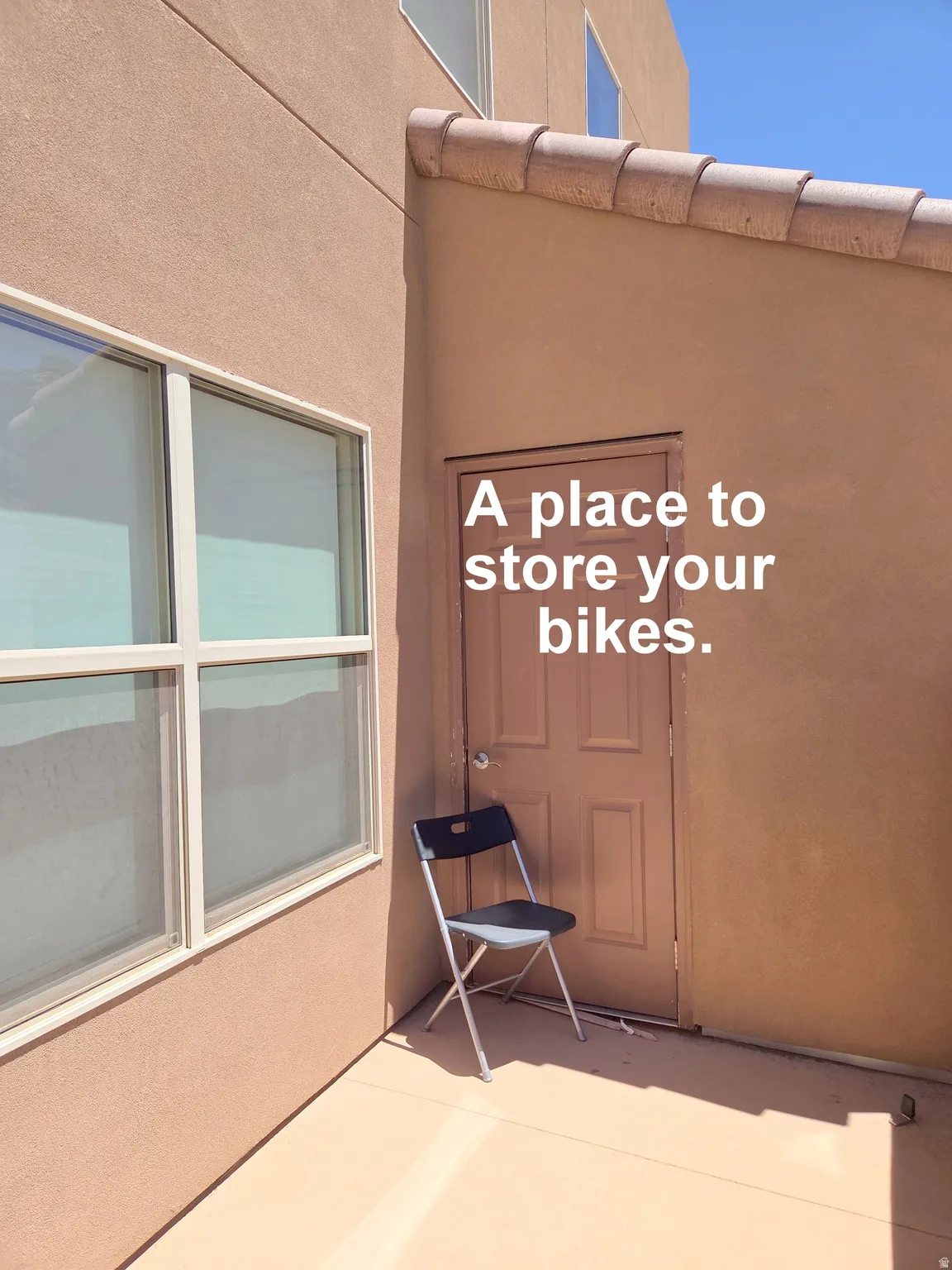 Exterior front porch Storage. With stucco wall with integrated door and window, featuring a tile roof overhang and a concrete ground surface