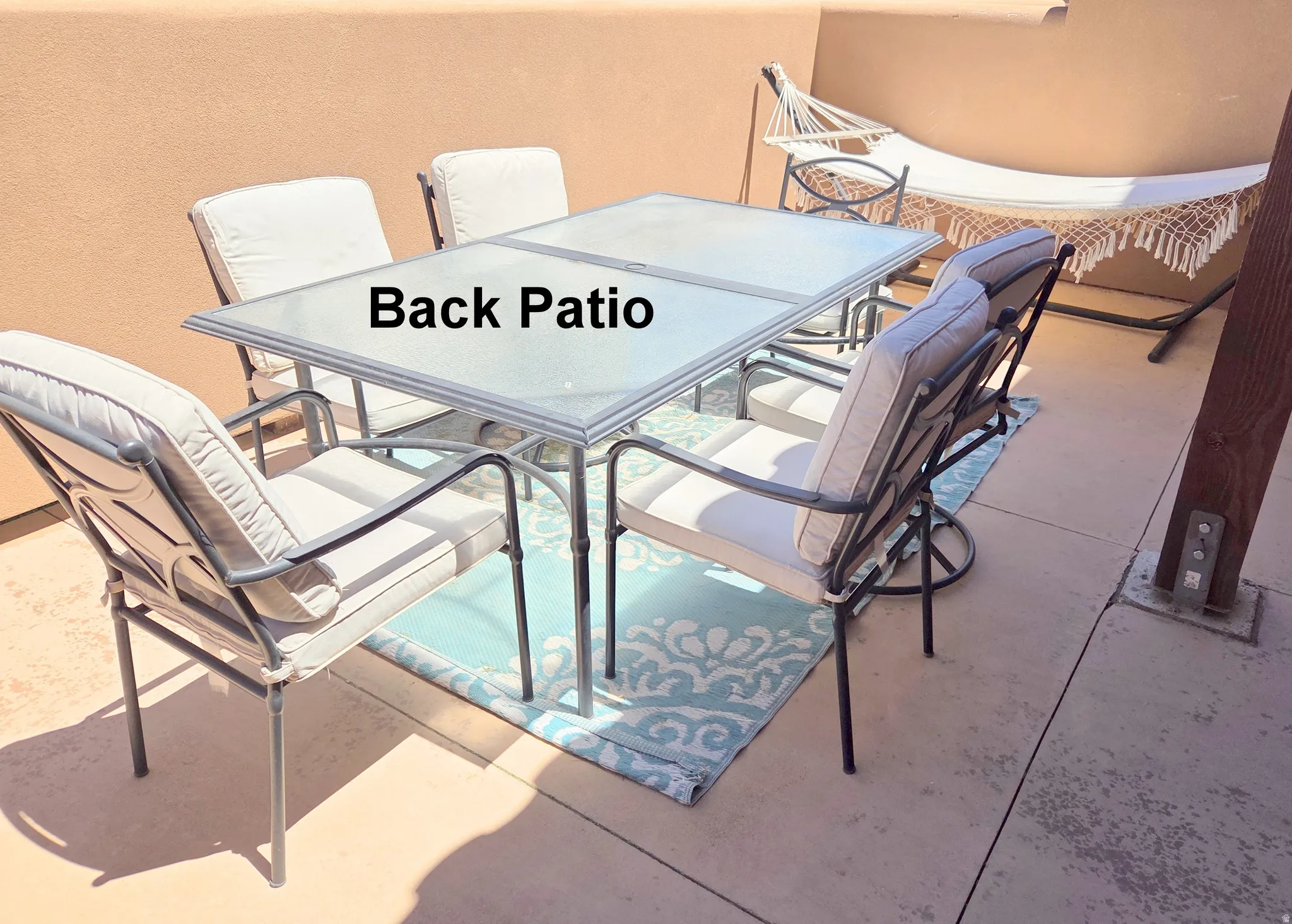 Concrete patio dining just off the kitchen with stucco walls