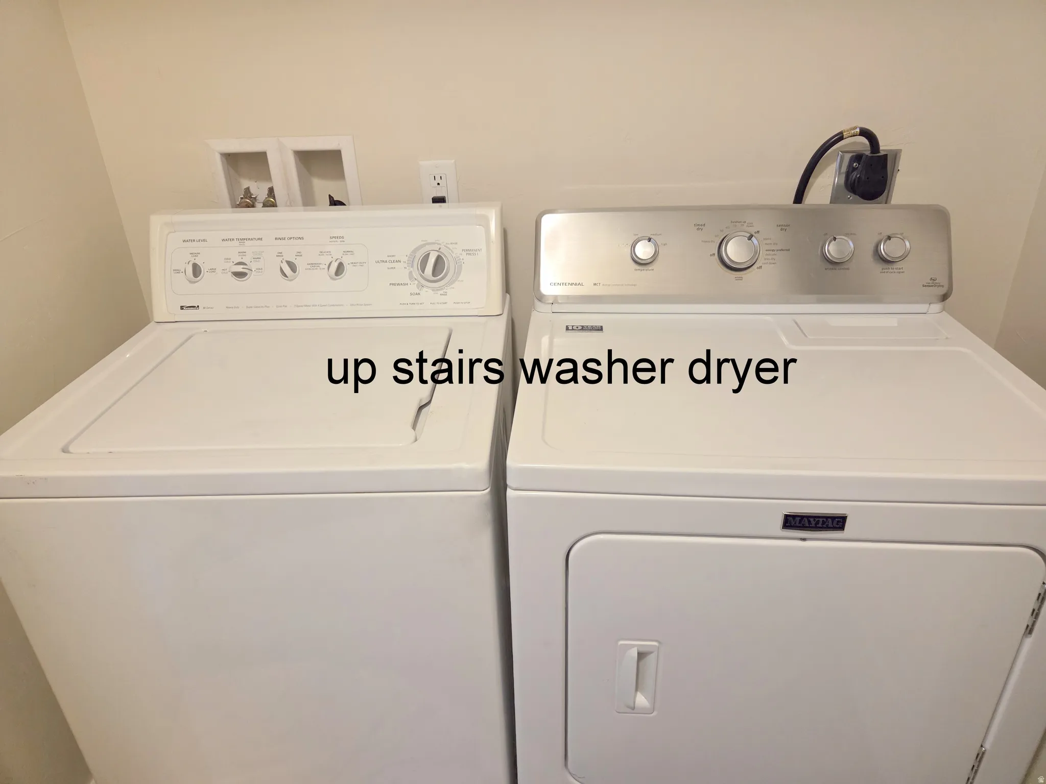 Dedicated laundry area featuring a white top-load washing machine and a white front-load dryer